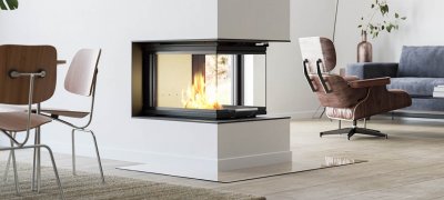 Large fireplace Scan 5005 FRL as room divider with glass on three sides and door with lifting function in living room with dining room and blue wall behind