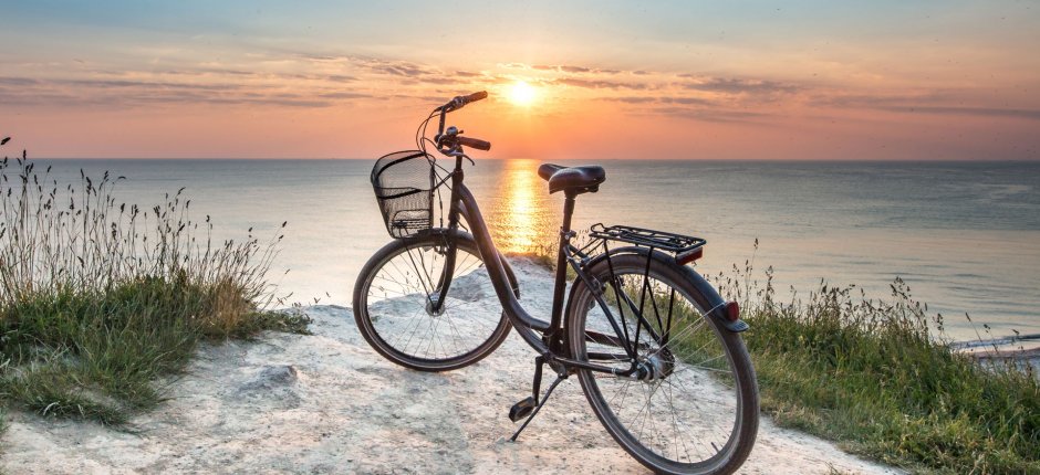 Bicycle standing at a danish beach in the sunset