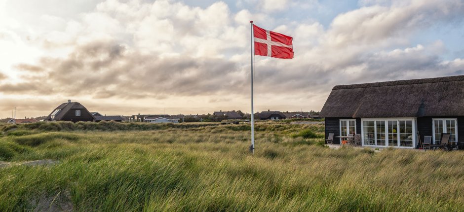 Two cottages in the danish sand dunes with danish flag