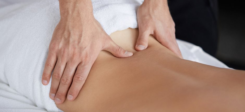 Hands massaging a womans back