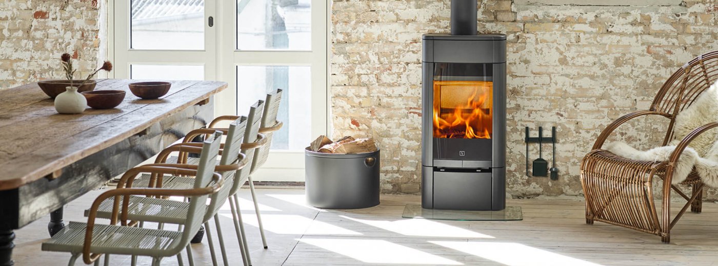 Scan 65-1 stove in Scandinavian interior in front of a light brick wall