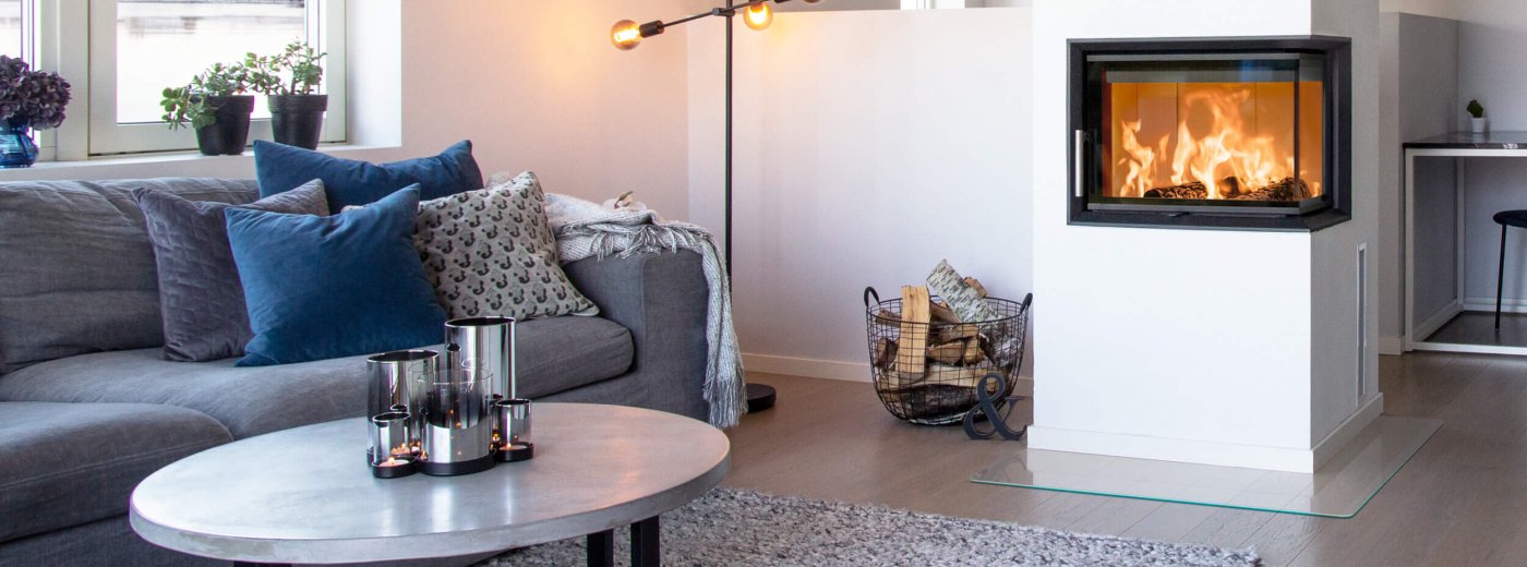 Gray sofa in modern white home with large white fireplace Scan 5003 FR with flames