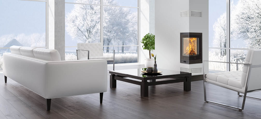 Tall and narrow fireplace insert Scan 1008 for corner with glass on two sides and black glass frame in a modern white living room with a dark floor and freezing winter outside