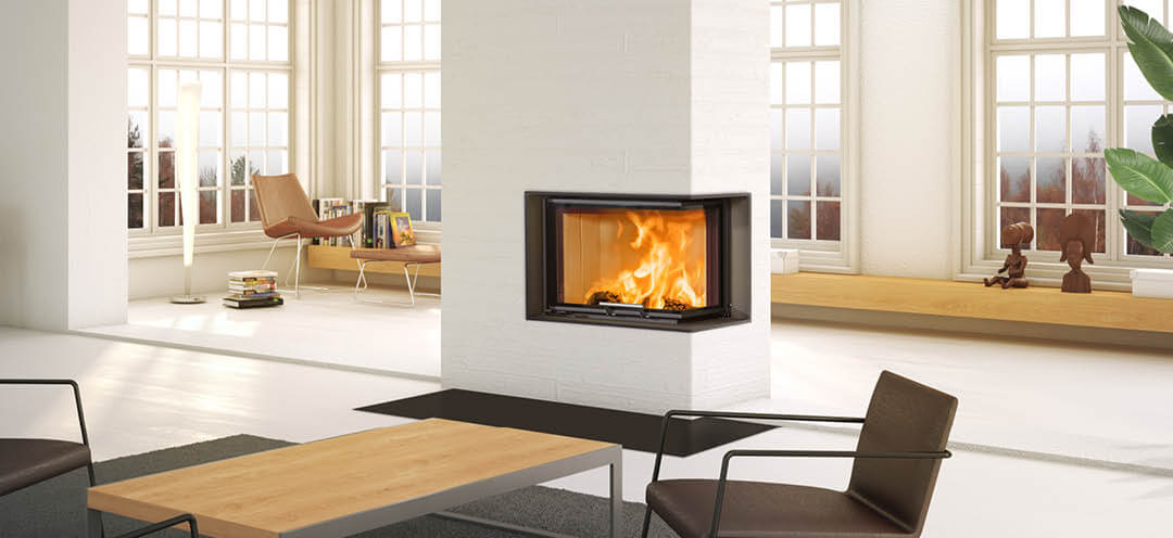 Large white fireplace with black fireplace insert Scan 5004 with lift-up door and glass on two sides, located in the middle of the white living room with large windows with bench and bars behind