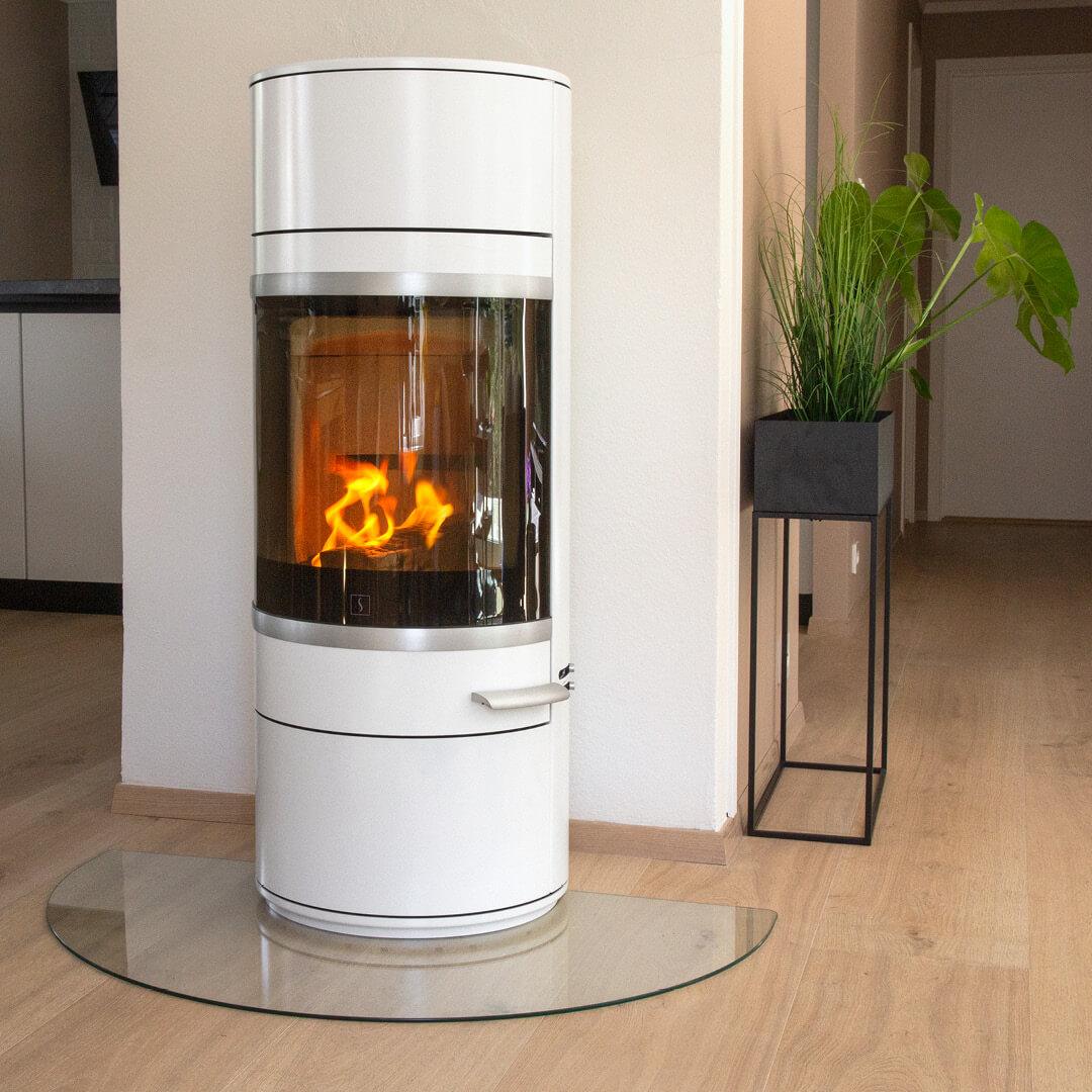 White wood-burning stove Scan 83-2 mounted in front of the firewall