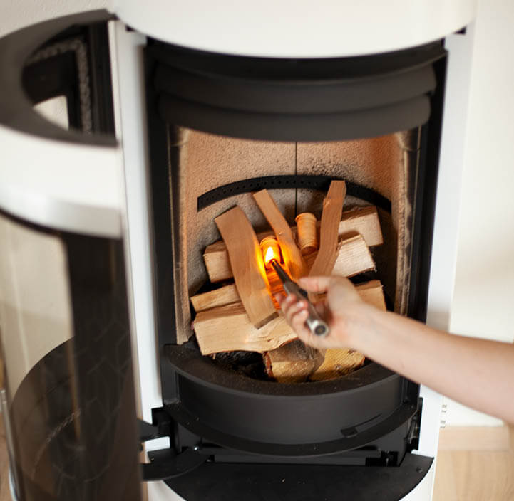 Close-up inside a fireplace of how you stack the fire